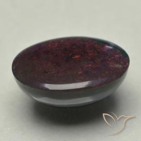 0.74カラットの天然マルチカラーブラックオパール（8×6.1 mm・オーバルカット）
