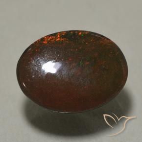 0.89カラットの天然マルチカラーブラックオパール（8×6.1 mm・オーバルカット）