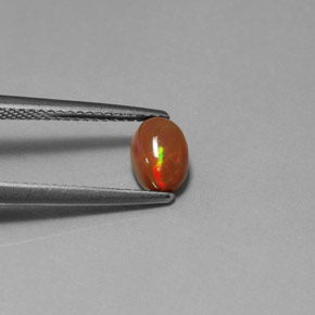 0.63カラットの天然マルチカラーチョコレートオパール（7×5.1 mm・透明）