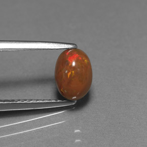 0.69カラットの天然マルチカラーチョコレートオパール、オーバルカット、オペーク