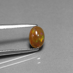 0.54カラットの天然マルチカラーチョコレートオパール、オーバルカット、オペーク