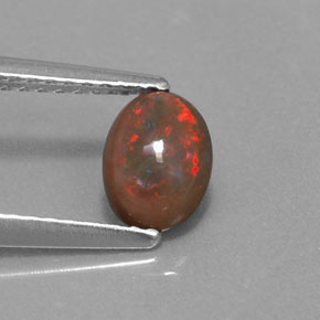 0.41カラットの天然マルチカラーチョコレートオパール、オーバルカット、半透明