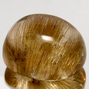 128.20カラットの天然無色＆ゴールドルチルクォーツ（31.8×26.5 mm・透明）