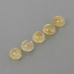 カラットの天然無色＆ゴールドルチルクォーツ（6.97 mm・ラウンドカット）