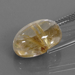 7.07カラットの天然無色＆ゴールドルチルクォーツ（13.9×10 mm・オーバルカット）